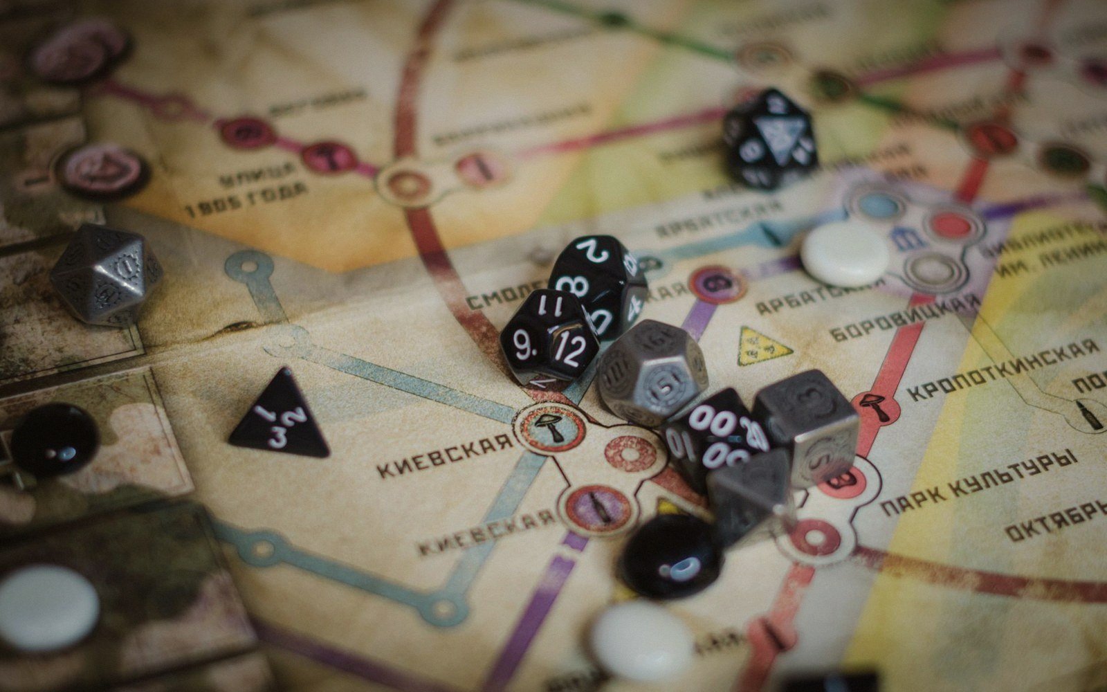 Multi-sided dice and game pieces scattered across a Moscow metro map